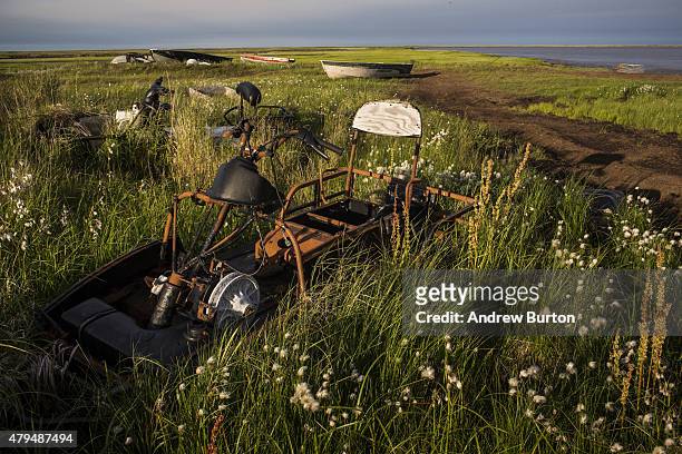 Destroyed snow machine lies in the grass on July 3, 2015 in Newtok, Alaska. Newtok is one of several remote Alaskan villages that is being forced to...