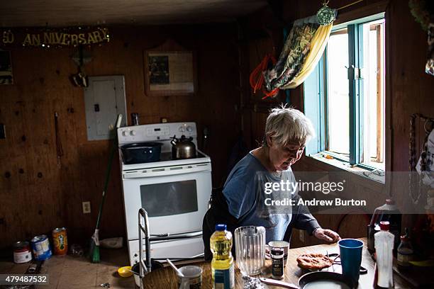 Mary Tom makes a cup of tea in her house on July 3, 2015 in Newtok, Alaska. Newtok is one of several remote Alaskan villages that is being forced to...