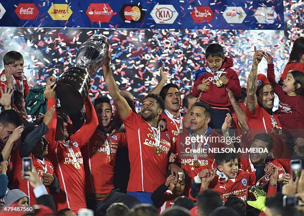 Chilean players celebrate after winning the 2015 Copa America football championship final against Argentina, in Santiago, Chile, on July 4, 2015....