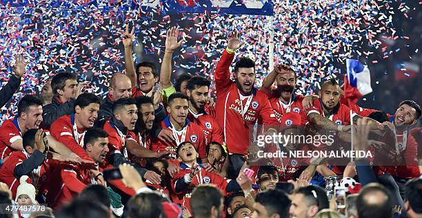 Chilean players celebrate after winning the 2015 Copa America football championship final against Argentina, in Santiago, Chile, on July 4, 2015....