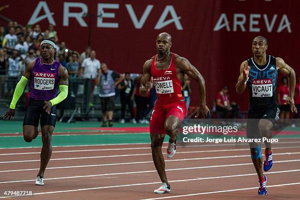 Michael Rodgers , Asafa Powell and Jimmy Vicaut compete in the Men's 100m during the Meeting Areva - IAAF Diamond League at Stade de France on July...