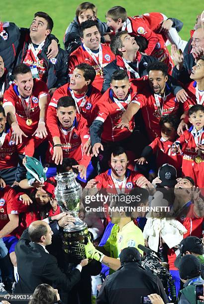 Chilean players celebrate after winning the 2015 Copa America football championship final against Argentina, in Santiago, Chile, on July 4, 2015....