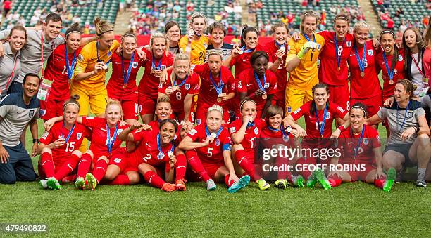 England's players celebrate their 1-0 win over Germany in the bronze medal match at the FIFA Women's World Cup in Edmonton, Alberta on July 4, 2015....