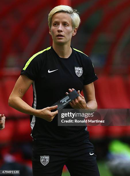 Megan Rapinoe of the United States of America stretches during a training session prior to the FIFA Women's World Cup Canada 2015 Final between...