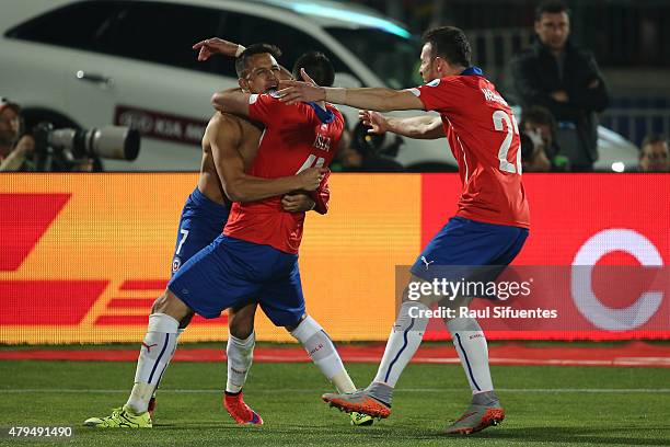 Alexis Sanchez of Chile celebrates with teammates Mauricio Isla and Angelo Enriquez after winning the 2015 Copa America Chile Final match between...