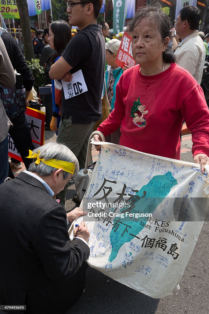 Signing an anti-nuclear flag during a protest against a...