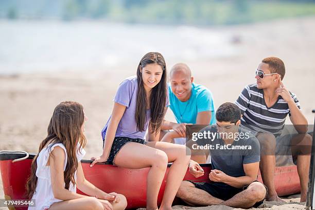 friends on a canoe trip together - summer camp canoe stock pictures, royalty-free photos & images