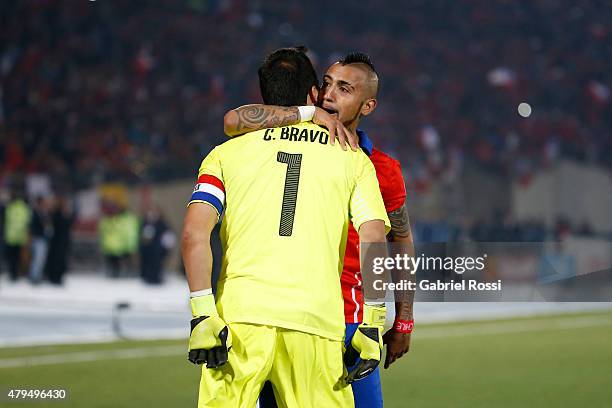 Claudio Bravo of Chile celebrates with teammate Arturo Vidal after winning the 2015 Copa America Chile Final match between Chile and Argentina at...