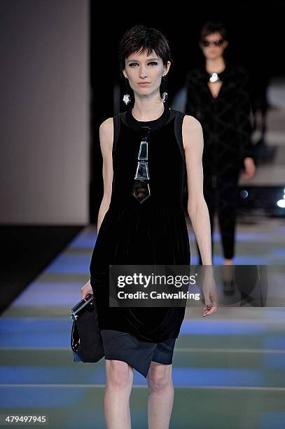 Model walks the runway at the Emporio Armani Autumn Winter 2014 fashion show during Milan Fashion Week on February 21, 2014 in Milan, Italy.