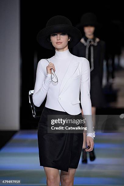 Model walks the runway at the Emporio Armani Autumn Winter 2014 fashion show during Milan Fashion Week on February 21, 2014 in Milan, Italy.