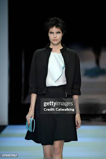 Model walks the runway at the Emporio Armani Autumn Winter 2014 fashion show during Milan Fashion Week on February 21, 2014 in Milan, Italy.