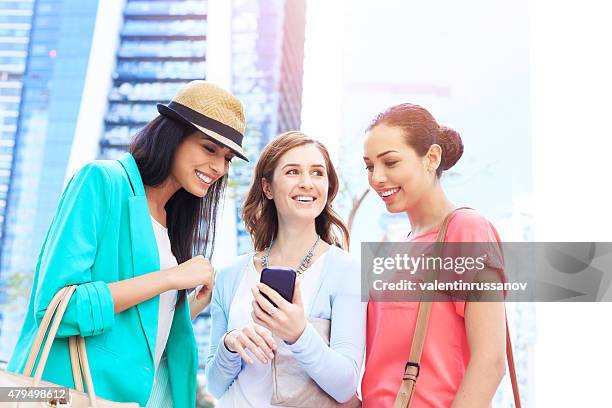 young girls using mobile phone in dubai - dubai marina stock pictures, royalty-free photos & images
