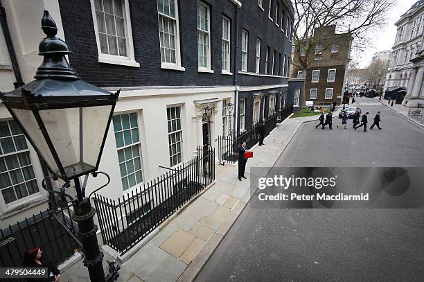 The Chancellor of the Exchequer George Osborne holds the budget box outside Number 11 Downing Street on March 19, 2014 in London, England. The...