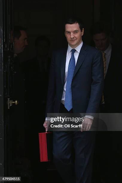 The Chancellor of the Exchequer George Osborne leaves Number 11 Downing Street holding the budget box on March 19, 2014 in London, England. The...