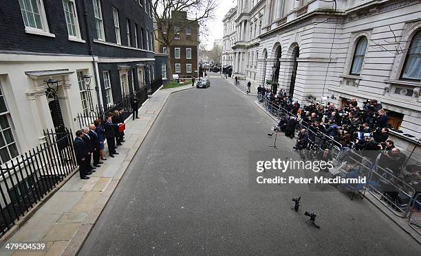 The Chancellor of the Exchequer George Osborne holding the budget box stands with his Treasury team outside Number 11 Downing Street on March 19,...