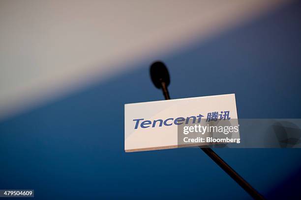 Microphone displays the Tencent Holdings Ltd. Logo during a news conference in Hong Kong, China, on Wednesday, March 19, 2014. Tencent, China's...