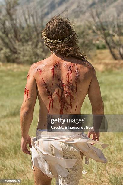 jesus walking with wounds on back - jesus walking stock pictures, royalty-free photos & images