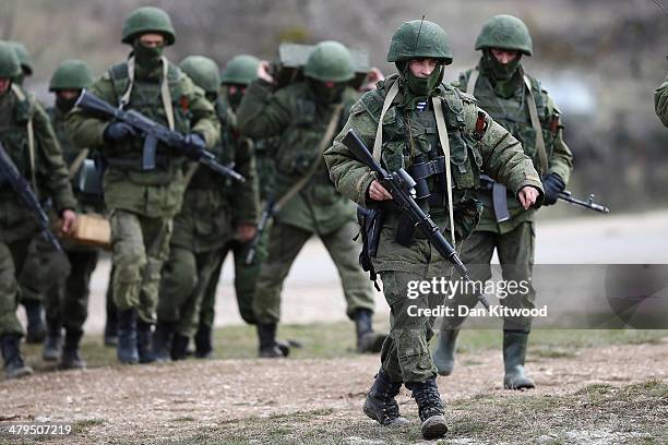 Russian military personnel move towards a Ukrainian military base on March 19, 2014 in Perevalnoe, Ukraine. Russia's Constitutional Court ruled...