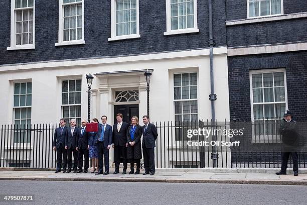 The Chancellor of the Exchequer George Osborne holding the budget box stands with his Treasury team Parliamentary Private Secretary to George Osborne...