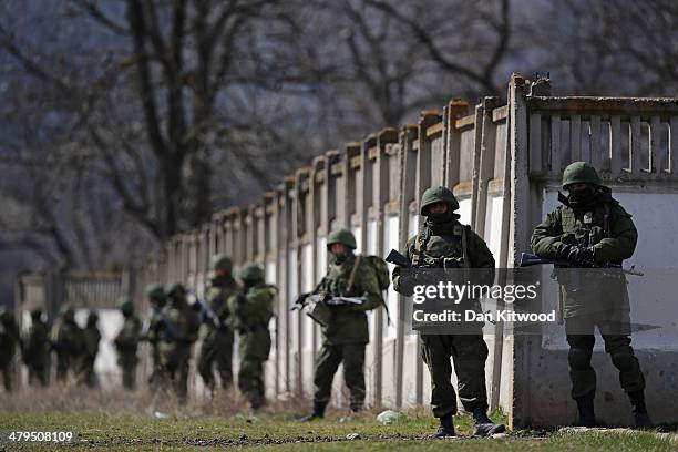 Russian military personnel surround a Ukrainian military base on March 19, 2014 in Perevalnoe, Ukraine. Russia's Constitutional Court ruled...