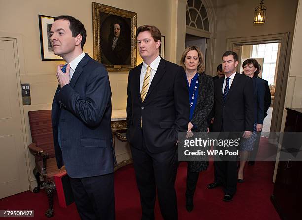 Chancellor of the Exchequer George Osborne and Chief Secretary to the Treasury Danny Alexander prepares to lead members of the Treasury team out of...