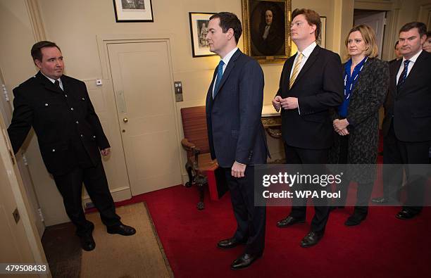 Chancellor of the Exchequer George Osborne and Chief Secretary to the Treasury Danny Alexander prepares to lead members of the Treasury team out of...