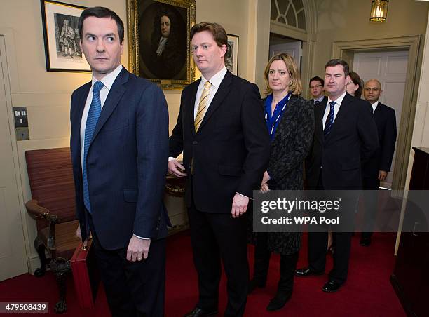 Chancellor of the Exchequer George Osborne and Chief Secretary to the Treasury Danny Alexander prepares to lead members of the Treasury team out of...