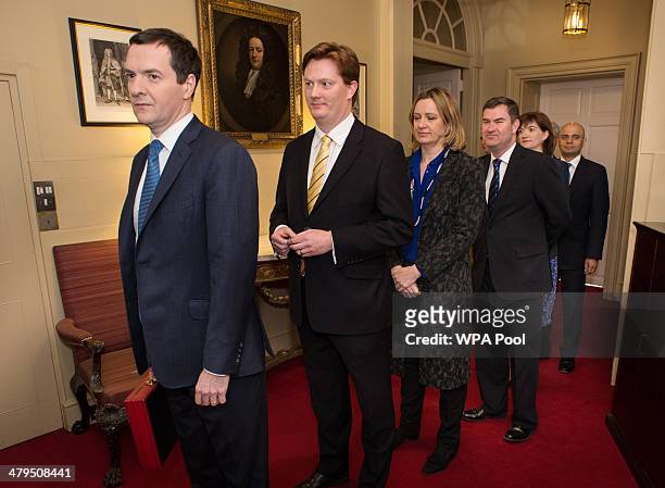 Chancellor of the Exchequer George Osborne and Chief Secretary to the Treasury Danny Alexander prepares to lead members of the Treasury team out of...