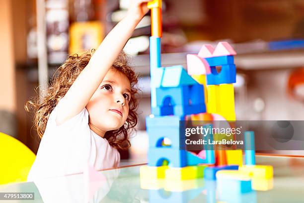 little girl building a house with cubes - mystical baby girls stock pictures, royalty-free photos & images