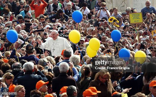 Pope Francis waves to the faithful as he holds his weekly audience in St. Peter's Square on March 19, 2014 in Vatican City, Vatican. Pope Francis...