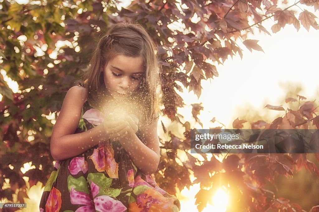 Autumn fairy in tree with magic fairy dust