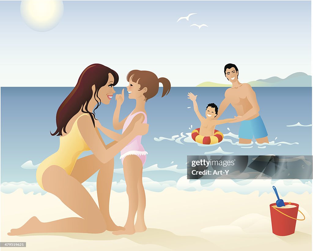 Family Spending Time Playing on Beach and in Water