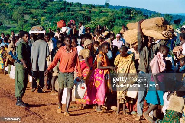 Refugees from Rwanda who have been forced to flee their homes by 12 days of ethnic carbage, are checked on April 19, 1994 at Gasenyi border, about...