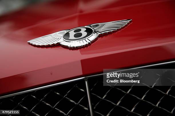Logo sits on the hood of a Bentley Continental GT convertible automobile, produced by Bentley Motors Ltd., following a news conference to announce...