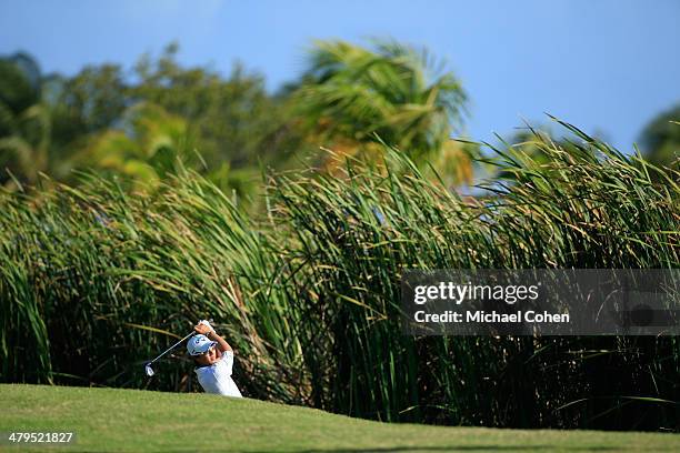 Ryo Ishikawa of Japan hits a shot from deep rough during the first round of the Puerto Rico Open presented by seepuertorico.com held at Trump...