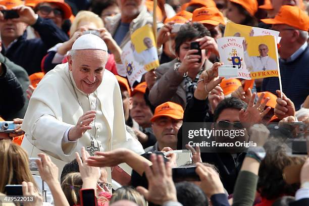 Pope Francis waves to the faithful as he holds his weekly audience in St. Peter's Square on March 19, 2014 in Vatican City, Vatican. Pope Francis...