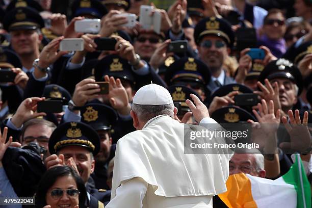 Pope Francis waves to the faithful as he holds his weekly audience in St. Peter's Square on March 19, 2014 in Vatican City, Vatican. Pope Francis...