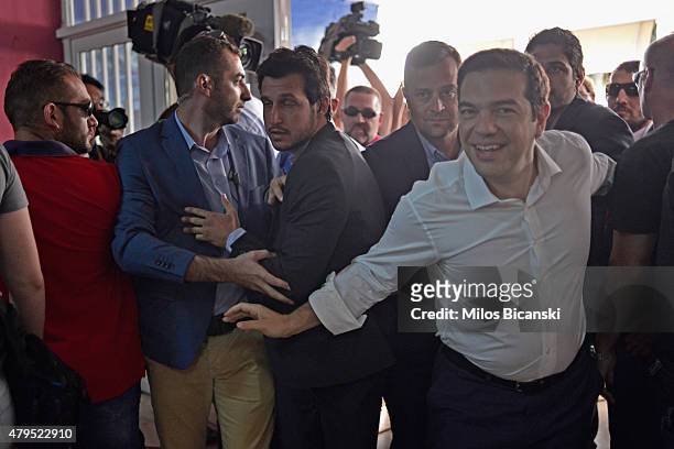 Greek Prime Minister Alexis Tsipras arrives at a local school in the suburbs of Athens to vote in the austerity referendum on July 5, 2015 in Athens,...