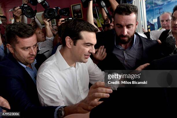 Greek Prime Minister Alexis Tsipras leaves a local school in the suburbs of Athens after voting in the austerity referendum on July 5, 2015 in...