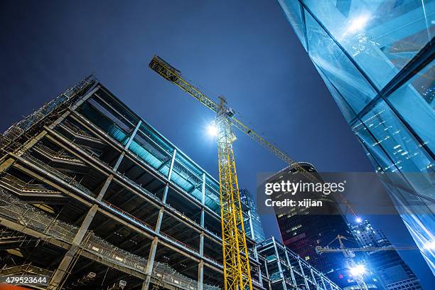 building under construction - construction crane asia stock pictures, royalty-free photos & images