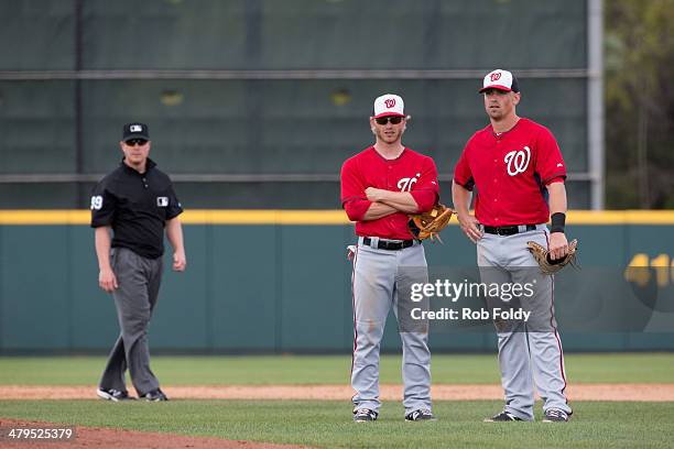 Tyler Moore and Mike Fontenot look on as Jerry Blevins of the Washington Nationals warms up during the spring training game against the Houston...