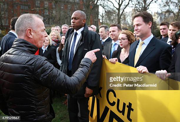 Protester Bill Maloney gestures as he shouts at Deputy Prime Minister Nick Clegg who abandoned a photocall near Parliament to promote a tax cut...