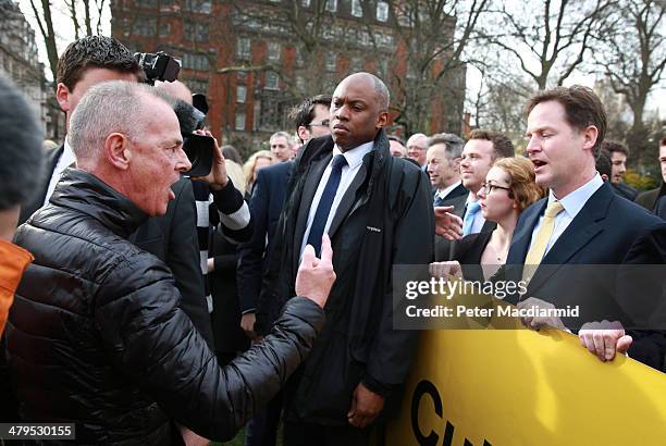 Protester Bill Maloney gestures as he shouts at Deputy Prime Minister Nick Clegg who abandoned a photocall near Parliament to promote a tax cut...