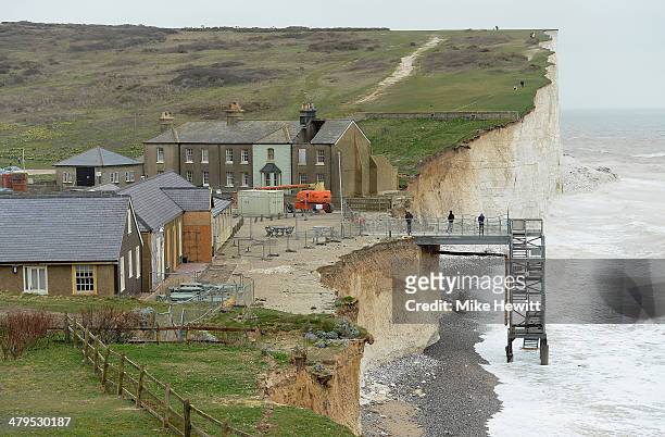 Work begins today to demolish the end terrace cottage at Birling Gap on March 19, 2014 near Eastbourne, United Kingdom. The ex-coastguard cottage was...