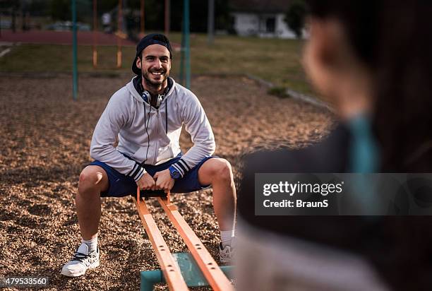 young happy man having fun with his girlfriend on seesaw. - gungbräda bildbanksfoton och bilder
