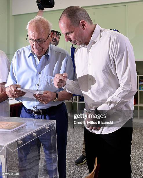 Greek Finance Minister Yanis Varoufakis with his father after placing his vote in the austerity referendum at a local school in the suburbs of Athens...