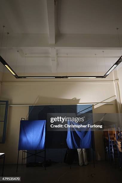 Man stands in the voting booth after marking his polling slip at a school near the Acropolis on July 5, 2015 in Athens, Greece. The people of Greece...