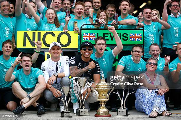 Lewis Hamilton of Great Britain and Mercedes GP celebrates with his team including Nico Rosberg of Germany and Mercedes GP and his mother Carmen...