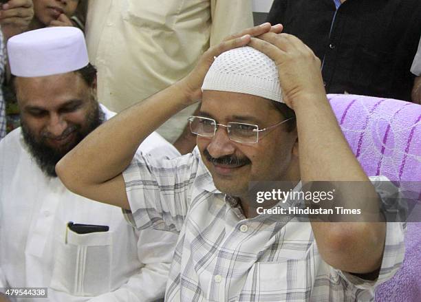 Delhi Chief Minister Arvind Kejriwal wearing skull cap during the Iftar party at Karawal Nagar on July 5, 2015 in New Delhi, India.