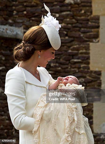 Catherine, Duchess of Cambridge, carries Princess Charlotte of Cambridge as they arrive at the Church of St Mary Magdalene on the Sandringham Estate...